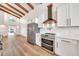 Updated kitchen with stainless steel appliances, white cabinets, and stylish backsplash at 4601 E Carolina Dr, Phoenix, AZ 85032