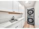 Laundry room featuring stacked washer and dryer and quartz countertops at 4601 E Carolina Dr, Phoenix, AZ 85032