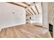 Bright, open living room with vaulted ceilings, wood beams, fireplace and wood floors at 4601 E Carolina Dr, Phoenix, AZ 85032