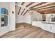 Bright open living space featuring wood beam ceiling, modern lighting and views of the kitchen at 4601 E Carolina Dr, Phoenix, AZ 85032