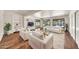 Bright living room with hardwood floors, a comfortable white sofa set, and sliding glass doors to the backyard at 4601 E Carolina Dr, Phoenix, AZ 85032