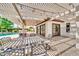 Inviting covered patio with elegant outdoor furniture and string lights, perfect for entertaining at 4601 E Carolina Dr, Phoenix, AZ 85032