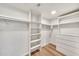 Spacious walk-in closet featuring wood-look floors and custom shelving at 4601 E Carolina Dr, Phoenix, AZ 85032
