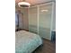 Cozy bedroom with modern lighting, a closet with mirrored sliding doors, and a decorative bedspread at 4610 N 68 N St # 476, Scottsdale, AZ 85251