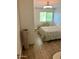 Comfortable bedroom with a window, decorative bedspread, and wood-style flooring at 4610 N 68 N St # 476, Scottsdale, AZ 85251