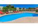 Sparkling community pool featuring lounge chairs, mature trees, and a privacy fence at 4610 N 68 N St # 476, Scottsdale, AZ 85251