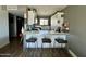 Modern kitchen featuring a bar top, stainless steel appliances, and black swivel chairs at 4610 N 68 N St # 476, Scottsdale, AZ 85251