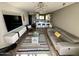 Bright living room with a modern lighting fixture, a colorful rug, and a gray sofa at 4610 N 68 N St # 476, Scottsdale, AZ 85251