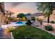 Lush backyard with mature trees, landscaping, and a sparkling pool in the distance at 4618 W Pokeberry Ln, Phoenix, AZ 85083