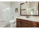 Traditional bathroom showcasing a tile shower with a glass door and vanity with wood cabinets at 4618 W Pokeberry Ln, Phoenix, AZ 85083