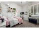 Bright bedroom featuring neutral walls, a window with shutters, decorative shelves and a workspace at 4618 W Pokeberry Ln, Phoenix, AZ 85083