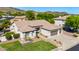 A stylish, desert home features a pristine lawn, desert landscaping, and a convenient three-car garage at 4618 W Pokeberry Ln, Phoenix, AZ 85083