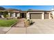 Charming home with a well-manicured front yard, desert landscaping, and a three-car garage, set against a mountainous backdrop at 4618 W Pokeberry Ln, Phoenix, AZ 85083