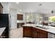 Open-concept kitchen with stainless appliances, a kitchen island, wine storage and adjacent dining area at 4618 W Pokeberry Ln, Phoenix, AZ 85083