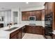 Spacious kitchen boasting dark cabinetry, stainless steel appliances, and a large center island at 4618 W Pokeberry Ln, Phoenix, AZ 85083