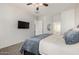 Cozy bedroom with plush carpet, ceiling fan, and an access door to the ensuite bathroom at 4618 W Pokeberry Ln, Phoenix, AZ 85083