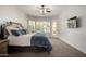 Cozy bedroom with plush carpet, ceiling fan, plantation shutters, and an access door to the outside at 4618 W Pokeberry Ln, Phoenix, AZ 85083