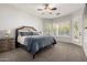 Cozy bedroom with plush carpet, ceiling fan, plantation shutters, and an access door to the outside at 4618 W Pokeberry Ln, Phoenix, AZ 85083
