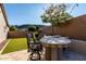 Outdoor kitchen features a built-in grill, bar seating, and lush landscaping, perfect for al fresco dining at 4618 W Pokeberry Ln, Phoenix, AZ 85083