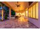Wide-angle view of covered patio featuring tile flooring, ceiling fans, and outdoor seating at 4618 W Pokeberry Ln, Phoenix, AZ 85083