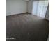 Bedroom with carpet, blinds, and natural light streaming through the windows at 5035 N 10Th Pl # 109, Phoenix, AZ 85014