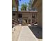 Exterior view of a well-maintained condo building with desert landscaping and stairs at 5035 N 10Th Pl # 109, Phoenix, AZ 85014