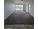 Living room with carpet, sliding glass doors and exterior access at 5035 N 10Th Pl # 109, Phoenix, AZ 85014