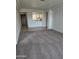Open-concept living room featuring neutral carpet and a view into the kitchen area at 5035 N 10Th Pl # 109, Phoenix, AZ 85014