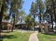 Community pool surrounded by trees and green space at 5035 N 10Th Pl # 109, Phoenix, AZ 85014
