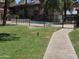 View of the community pool surrounded by grass at 5035 N 10Th Pl # 109, Phoenix, AZ 85014