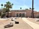 Casa La Mesa Clubhouse view, featuring a walkway, desert landscaping, and inviting arched entryways at 509 N Hobson Plz, Mesa, AZ 85203