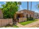 Charming home featuring stucco walls, decorative arches, and a lush front yard with mature trees at 509 N Hobson Plz, Mesa, AZ 85203