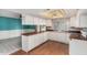 Open-concept kitchen featuring ample counter space, white cabinetry, and a view into the adjacent dining area at 509 N Hobson Plz, Mesa, AZ 85203