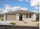 Charming single-story home featuring a neutral color palette, an attached two-car garage, and low maintenance landscaping at 5520 W Piedmont Rd, Laveen, AZ 85339