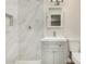 Updated bathroom with white marble tile, shower, and gray vanity at 556 S Forest --, Mesa, AZ 85204