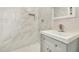 Updated bathroom with white marble tile, shower, and gray vanity at 556 S Forest --, Mesa, AZ 85204