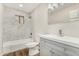 Updated bathroom with white marble tile, tub, and gray vanity at 556 S Forest --, Mesa, AZ 85204