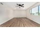 Bright bedroom featuring hardwood floors, a ceiling fan, and a window with natural light at 556 S Forest --, Mesa, AZ 85204