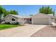 Charming single-story home with a spacious driveway and a well-manicured front yard at 556 S Forest --, Mesa, AZ 85204