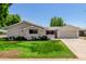 Charming single-story home featuring a well-maintained lawn, fresh paint, and attached garage at 556 S Forest --, Mesa, AZ 85204