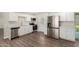 Bright kitchen featuring stainless steel appliances, white cabinets, and new flooring at 556 S Forest --, Mesa, AZ 85204