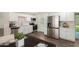 Bright, updated kitchen with stainless steel appliances, light cabinets, and wood floors at 556 S Forest --, Mesa, AZ 85204