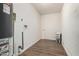 Bright laundry room with wood floors, paint, washer hookups, water heater, and white door at 556 S Forest --, Mesa, AZ 85204