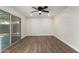 Open-concept living area boasts hardwood floors and ample natural light from sliding glass doors at 556 S Forest --, Mesa, AZ 85204