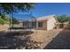 View of house from backyard with trampoline; house has tile roof at 7930 W Colter St, Glendale, AZ 85303