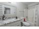 Well-maintained bathroom featuring a shower-tub combo, granite vanity, and neutral decor at 7930 W Colter St, Glendale, AZ 85303