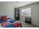 Bright bedroom with window, bookcase, and a Spiderman themed comforter at 7930 W Colter St, Glendale, AZ 85303