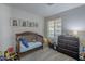 Charming bedroom featuring a crib, dresser and adorable animal artwork at 7930 W Colter St, Glendale, AZ 85303