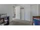 Neutral bedroom featuring a closet, open doorway, and carpet flooring at 7930 W Colter St, Glendale, AZ 85303