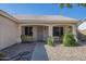 Inviting front porch featuring decorative plants, a security door, and desert landscaping at 7930 W Colter St, Glendale, AZ 85303
